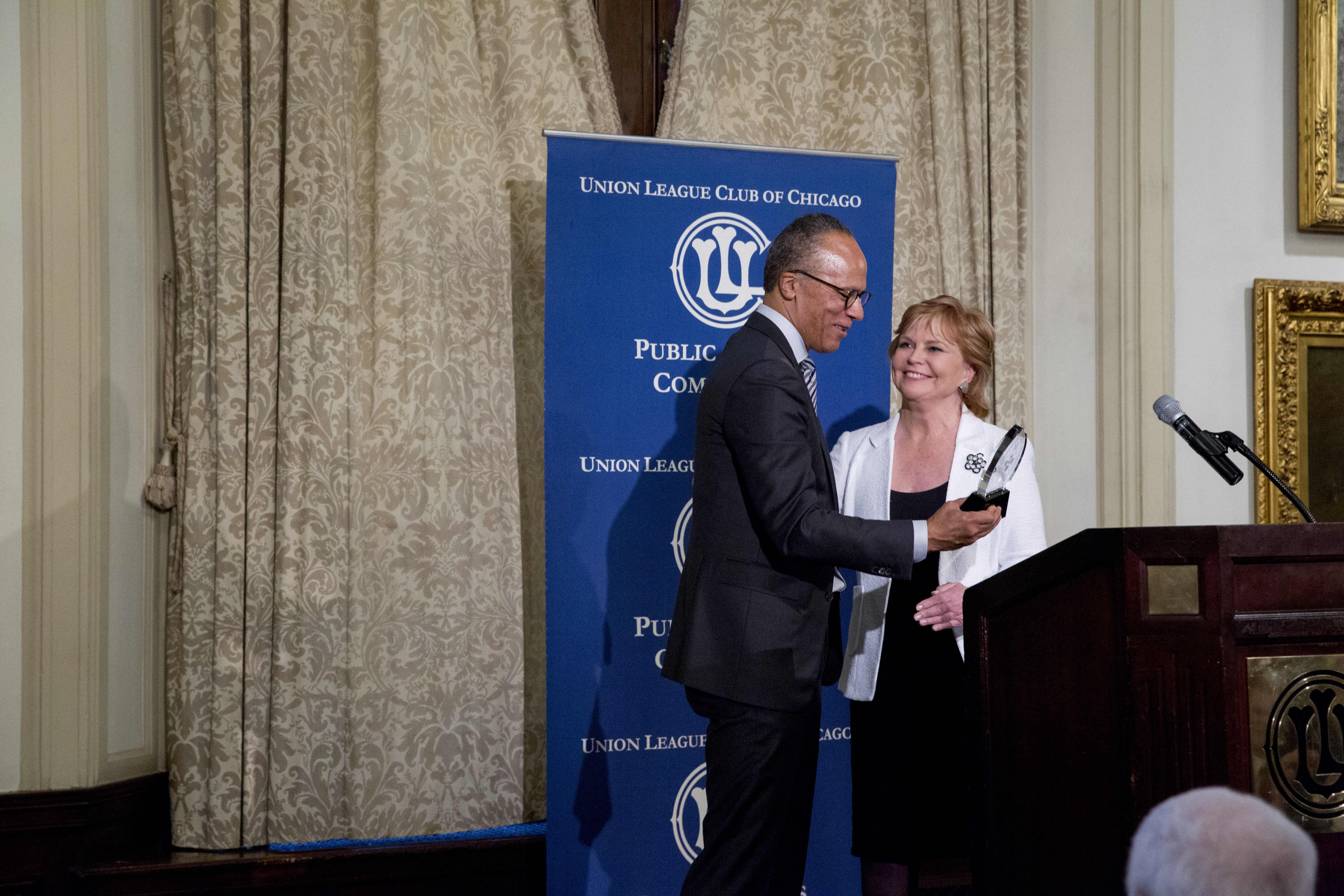 Carol Marin presents Lester Holt with the inaugural CJIE award.