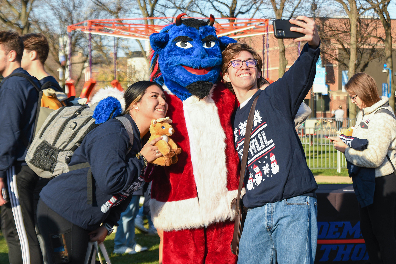 Students taking a picture with the DePaul mascot DIBS