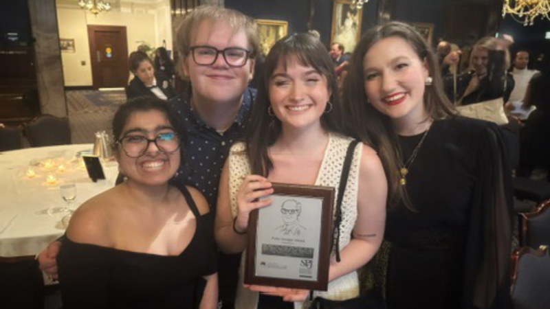 DePaulia Staff holding their 2025 Peter Lisagor Award
