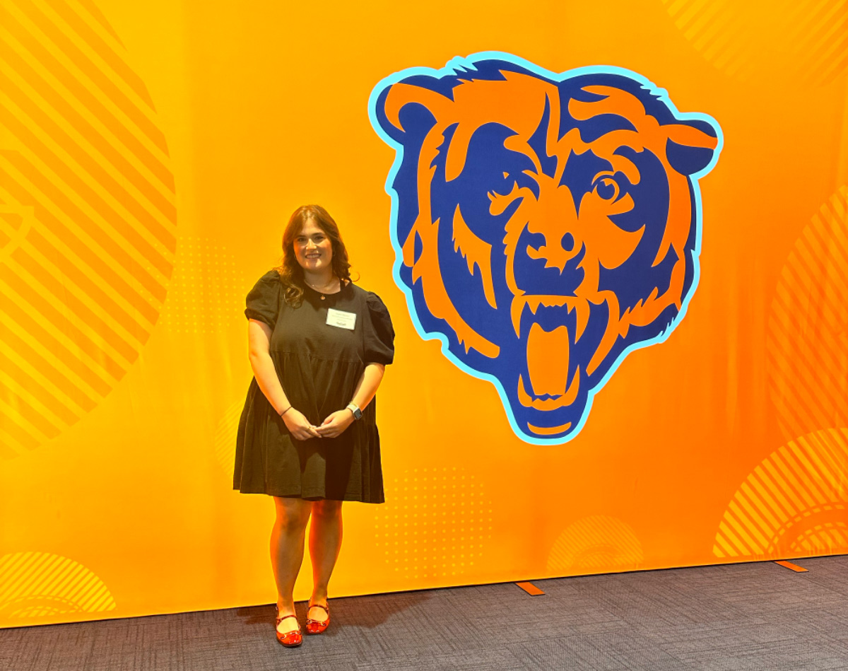 Taylor Gaston poses with the Chicago Bears Logo